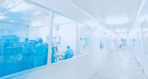 people in garments working behind in a cleanroom facility